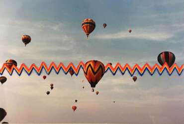 Marie Cameron, Zigzag Rainbow Balloon Scape,2021, Silk thread on found photograph, 4x6 inches, 9.5x11.5 in. framed